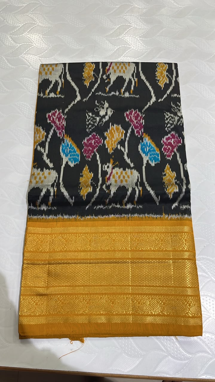 Unique Black Pochampally Ikat Silk Saree with Cow Motifs and Mustard Yellow Kanchi Border