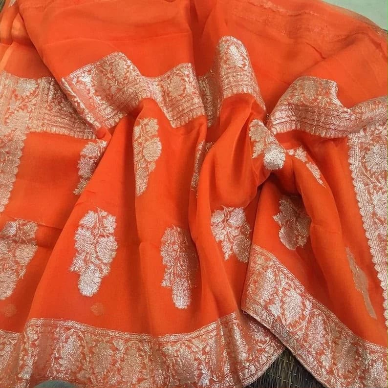 Handloom Banarasi Pure Khaddi Chiffon Saree – Vibrant Orange with Fine Silver Zari Floral Bootisand Border
