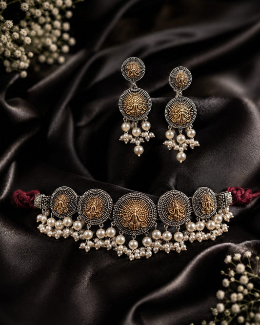 Beautiful dual tone oxidised peacock choker set adorned with white pearls and with matching earrings